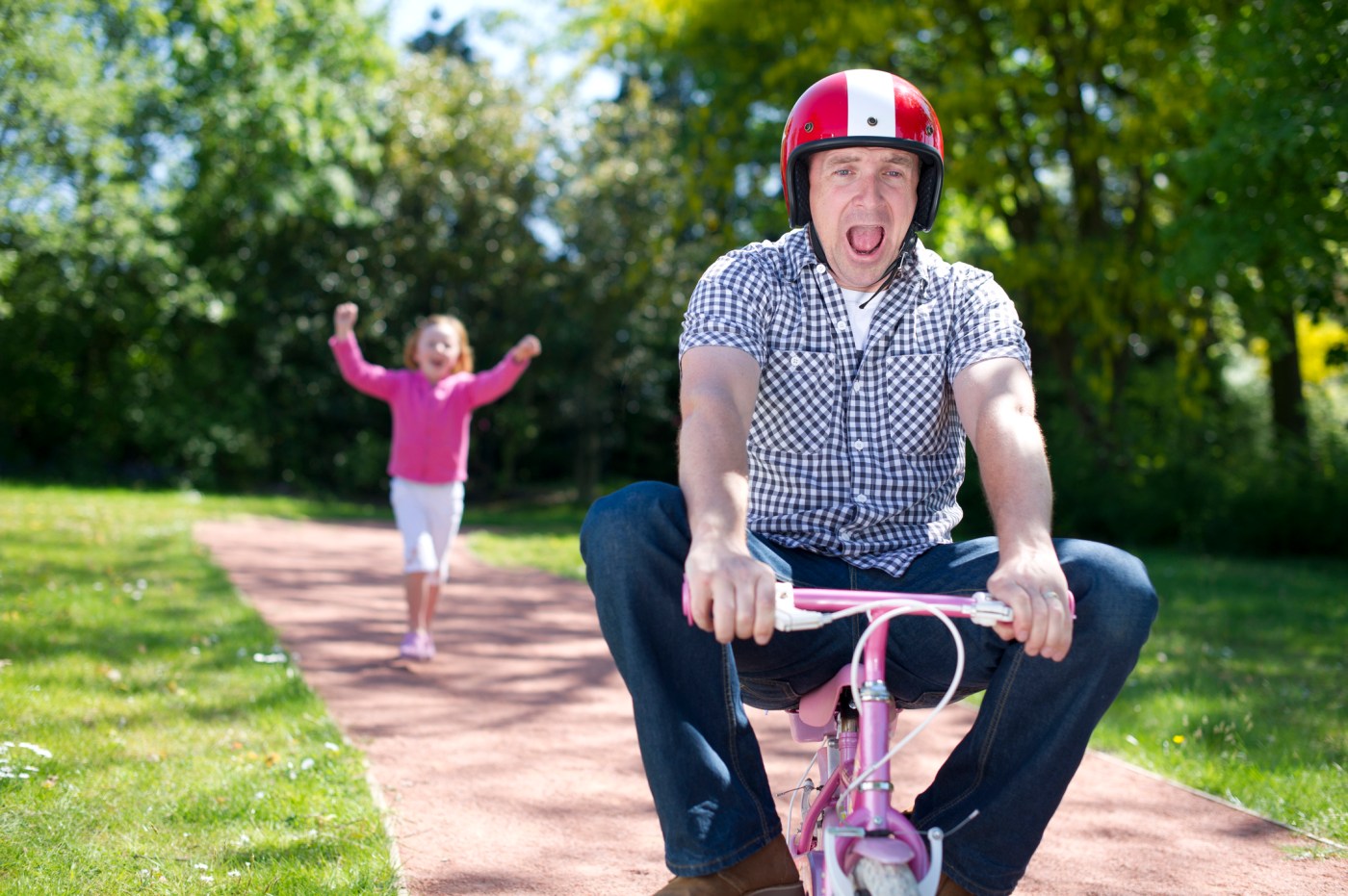 Photo of a Dad as he learns to ride a bike