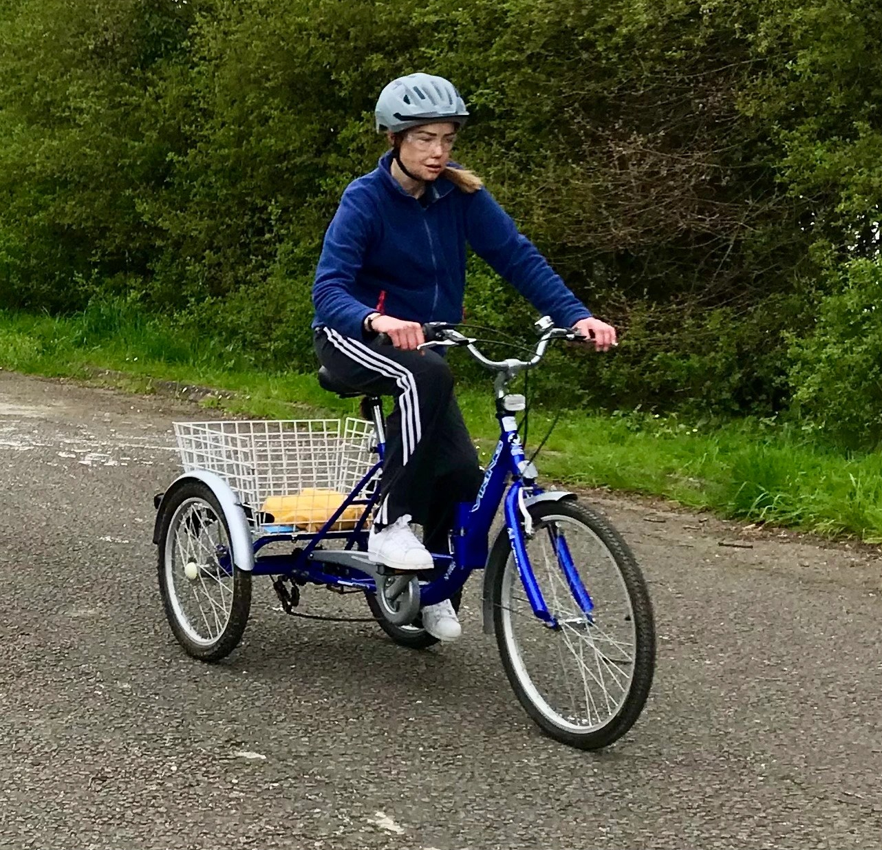 Photo of Cheryl riding her three wheeled bike