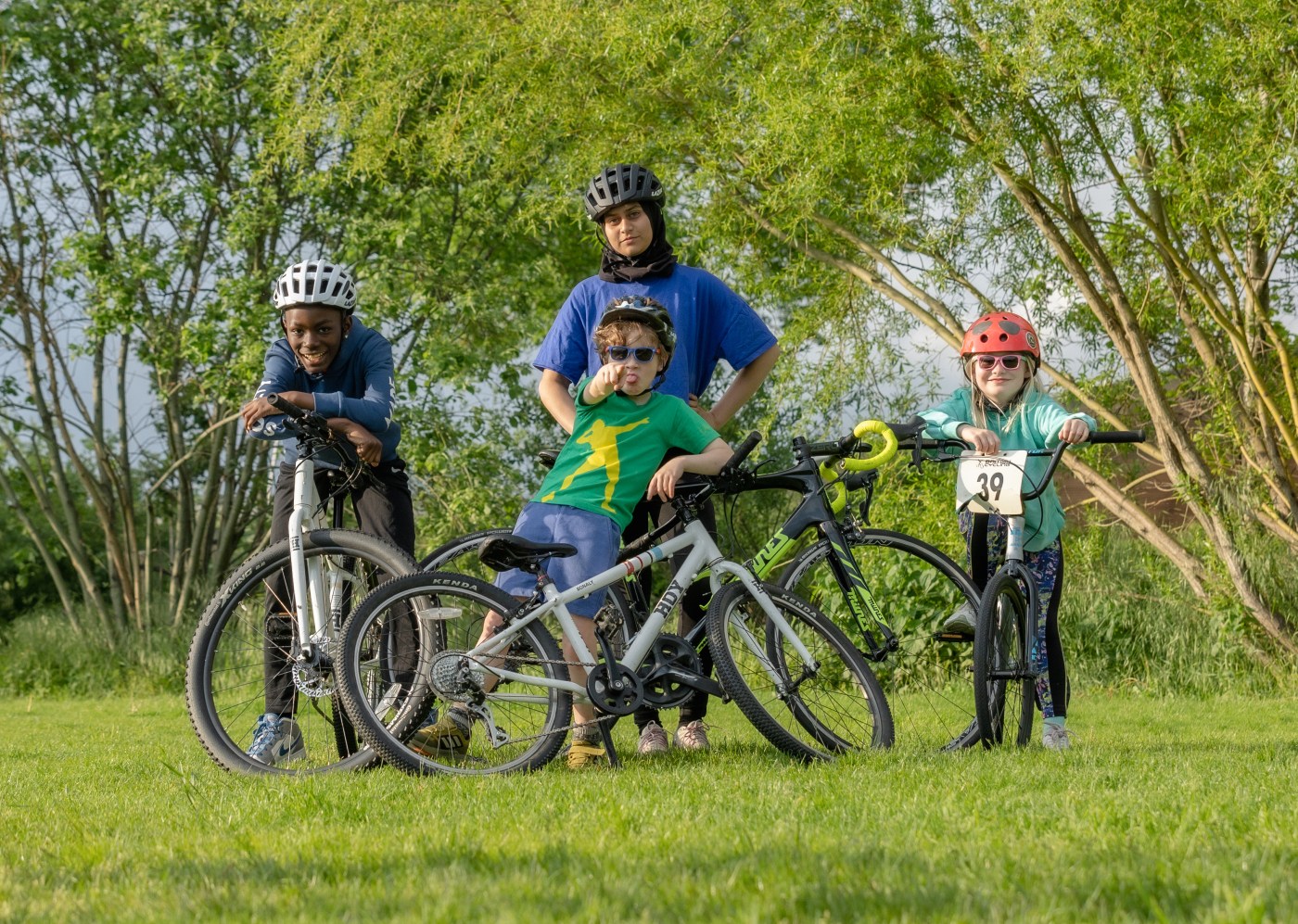Photo of a mum with her children and their bikes