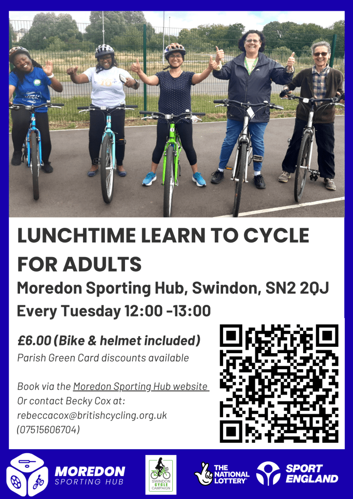A photo of a group of adults learning to ride bikes.  They are all smiling with their thumbs up 