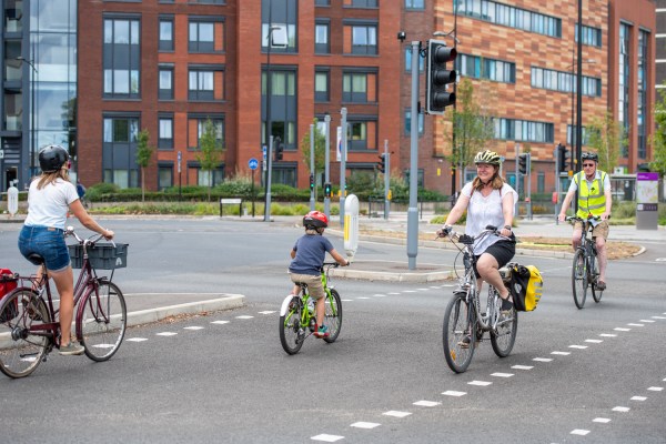 Image of the Whalebridge junction in Swindon with four cyclists pedalling across the dedicated cycle crossing