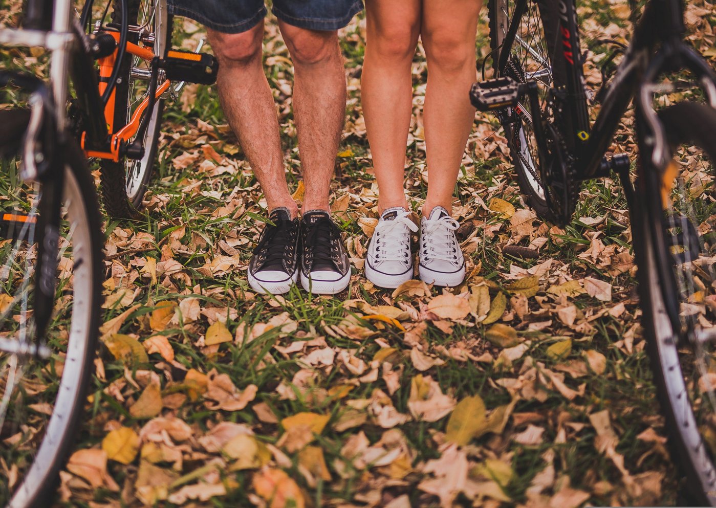 Photo of two cyclists legs in autumnal leaves